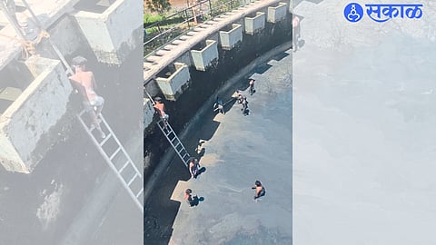 Acacia: Laborer removing sludge from water treatment plant.