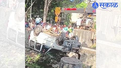 A car lying in a drain after an accident