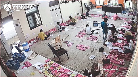 Staff scrutinizing applications at the head office of Agricultural Produce Market Committee.