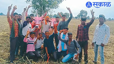 Contestants cheering in Gorane village after winning first place in the state-level bullock cart race