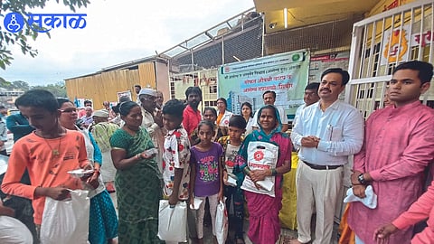 Chandrakant Dada More while distributing clothes to the needy during cleanliness campaign.