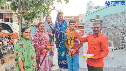 Dhanur: Parents feeding Khushal Gosavi. Along with village women.