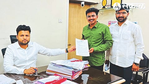 Jayesh Ahire of NCP Youth Congress giving a statement to District Deputy Registrar Fayaz Mulani regarding the mismanagement of market committee in Nampur.
