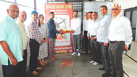 President Krunal Patil gifting flex used on tribal padas by CREDAI Nashik Metro