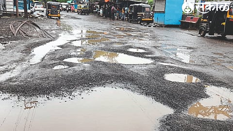 One to one and a half feet pits lying on the road near the Ram temple in the city.