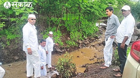Sarpanch Rohidas Katore and Gram Panchayat officials inspecting the chemical water released by an unknown vehicle in a drain on the Nashik-Mumbai highway.