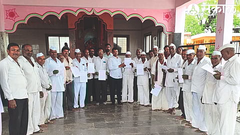 Agricultural assistant distributing crop insurance leaflets in Pimpalgaon Lep, Rajapur area.