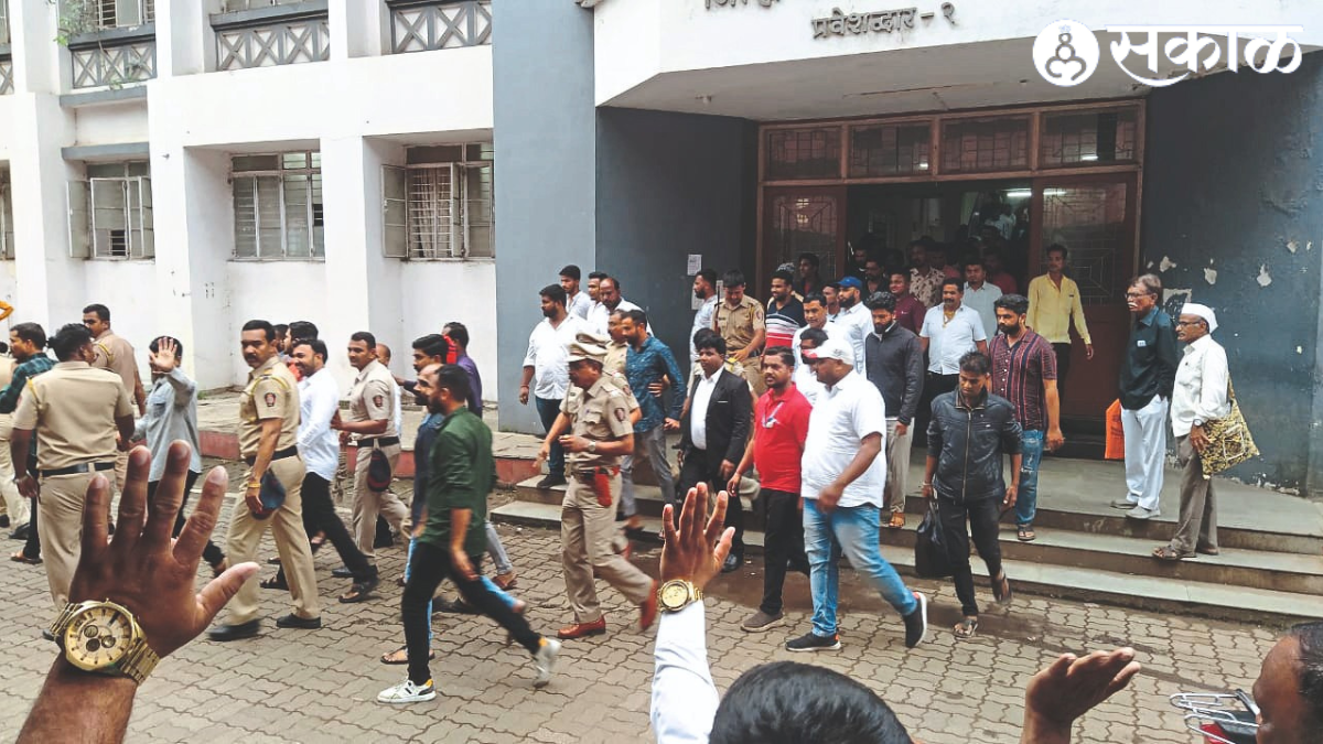 Police escorting Bhushan Londhe and others from the District Sessions Court premises