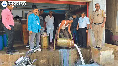 Employees destroying adulterated milk by Bharari team of district administration.