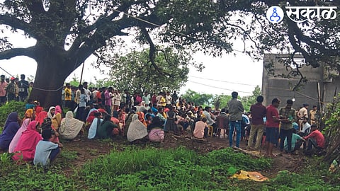 A crowd gathers at the burial site.