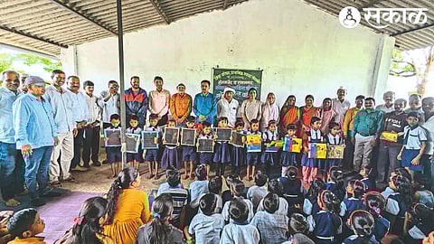 Members of social network forum distributing sports dress and educational materials to students of Zilla Parishad Primary School