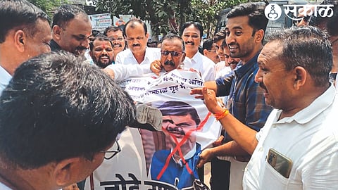 Activists of the Maratha community protest by hanging the image of state Home Minister Devendra Fadnavis in protest against police lathicharge on protesters in Jalna.
