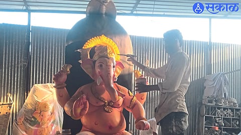 Chavan painter painting on Ganesha idol.