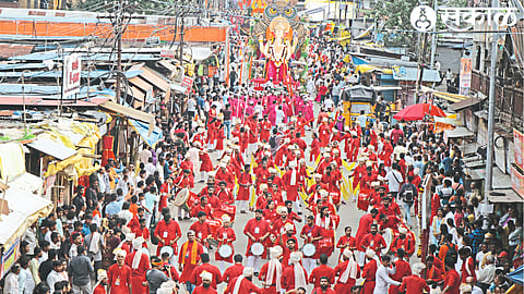 A grand Ganesha idol and continuous sound of drums in the immersion procession
