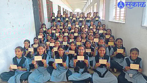 A student showing a letter written by a student of Adarsh Madhyamik Vidyalaya