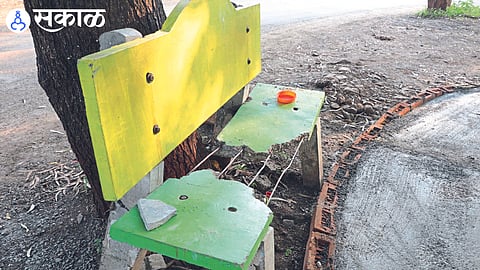 Broken benches on the banks of Mehrun Lake and in the second picture a broken and thrown away plaque of 'Swachh Shahr Sunder Shahr'.