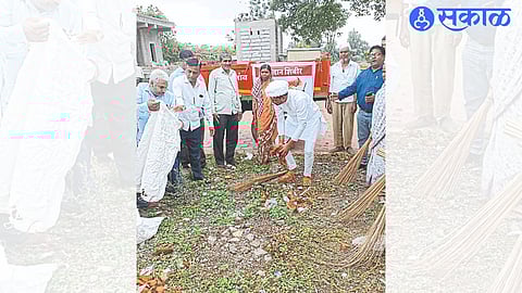 Nikhil Shewale and village council members cleaning the area of Rokdoba temple in Dabhadi.