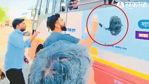 Protesters stopping a bus at Yewala on Sunday and blackening the poster of the state government on it.