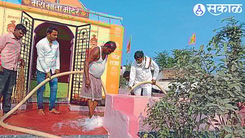 Social worker Namdev Mahajan while cleaning the Marimata temple. Neighbor Kailas Pawar and local residents.