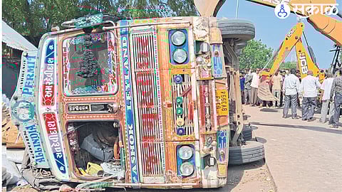 A truck overturned near a bus stand on Thursday.