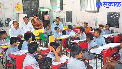 District Collector Ayush Prasad while sitting on the students' bench in Zilla Parishad School.