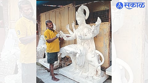 Sculptor turning his last hand on the idol on the occasion of Navratri