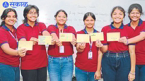 School students participating in letter writing activities.