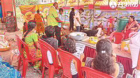 At Satananaka (Malegaon) women and men sitting by numbers to get snacks prepared by the chef.