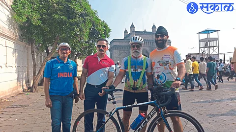 Cyclist with police officer Ravindra Singhal while welcoming Mohinder Singh Bharaj who completed his cycle ride from Kathmandu to Mumbai.