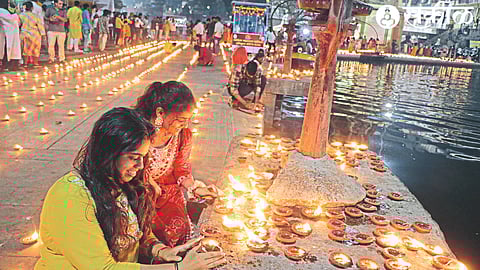 A young woman lighting a lamp during the Goda Dipot Festival organized by Sri Ramakrishna Health Institute and Nashik Municipal Corporation on Thursday.