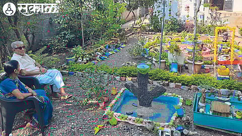 Grandparents relaxing and chatting in their self-made garden.