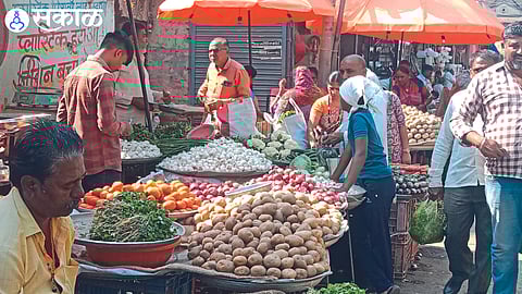 Garlic and other vegetables sold by vendors in the market.