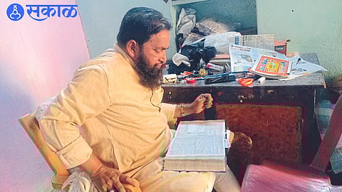 Astrologer Bismillah Nura Pinjari looking at Panchang.