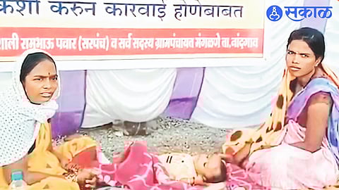 Mangalne Sarpanch Vaishali Pawar with her three-month-old baby sitting on an indefinite hunger strike outside the Panchayat Samiti.