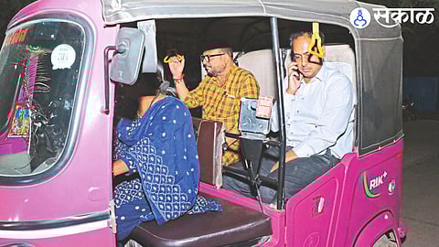 Guardian Minister Gulabrao Patil and Collector Ayush Prasad traveling in a pink autorickshaw driven by women after the inauguration of the Road Safety Week campaign in the city.
