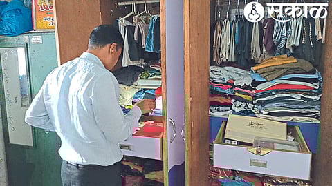 Police inspecting a cupboard broken by thieves.