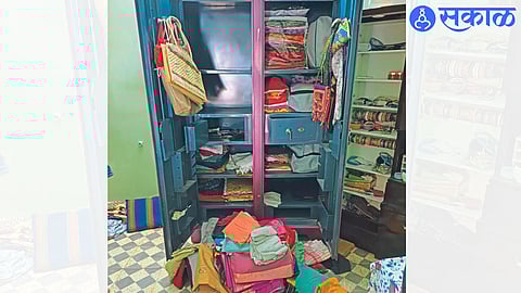 Dinesh Tawde's broken cupboards and safes, clothes and belongings thrown in disarray.
