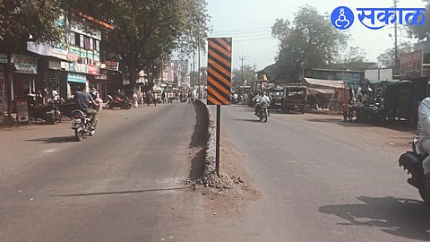 A radium notice board on the facade of the divider in front of the Mahatma Gandhi Multi-Purpose Hall.