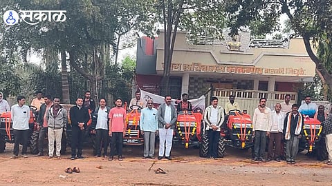People appointed Sarpanch Sanjay Bhamre and villagers during mass puja in Gram Panchayat as six farmers bought tractors for farming at one time in the village.