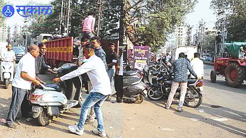Employees picking up a vehicle parked on the road.