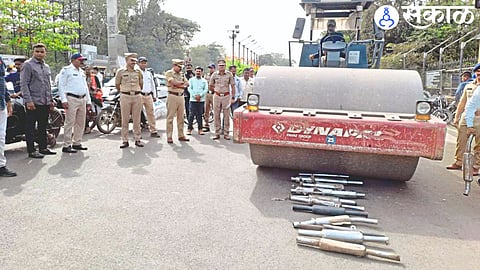 Roller crushing a silencer in the presence of police officers.