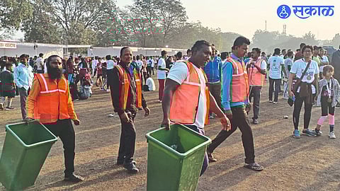 Municipal employees carrying out cleaning duties at the police training ground during the marathon on Sunday.