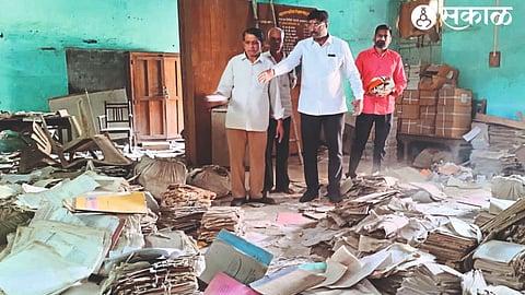 Ramdas Borse, Bharat Patil while showing the misplaced documents in the education board office.