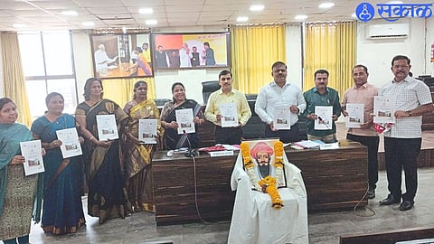 Gajanan Patil while handing over copy of budget to officials in municipal standing committee meeting.
