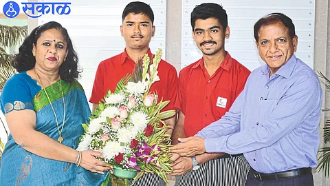 Sanjay Agarwal, Sunanda Menon felicitating the successful students Fahad Ansari, Rishabh Khadse of SVKM CBSE School.