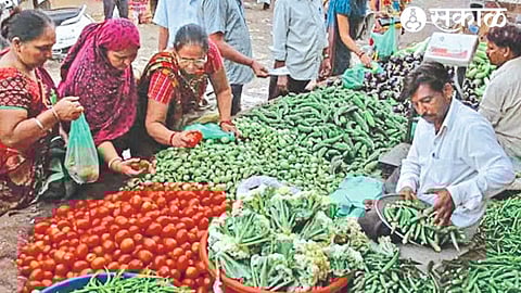 Women buying vegetables in the market.