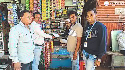 Municipal team while collecting fine from pantapari holder for finding tobacco products, scented betel nuts.