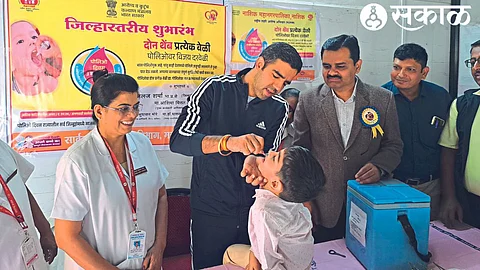Collector Jalaj Sharma giving a dose of polio to a child at a general hospital.