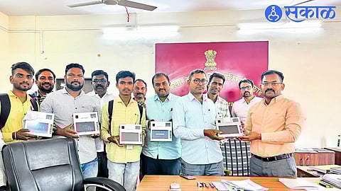 Tehsildar Vishal Naikwade distributing new e POS machines to ration shopkeepers.