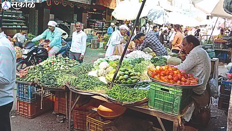 Consumers while buying vegetables in the market.